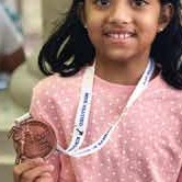 A young skater with her medal