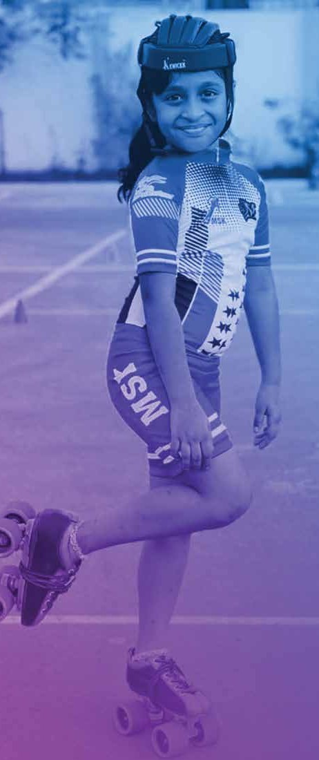 A young MSK skater in club kit on quad skates